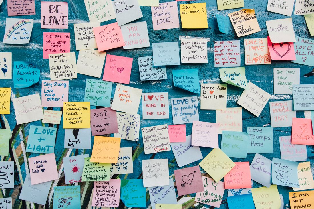 A wall of colourful post-its filled with positive affirmations and career goals