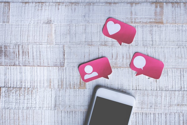 A phone and social media icons to communicate empathy and compassion 